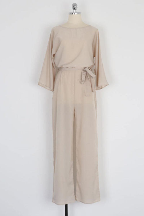 Beige casual long sleeve belted jumpsuit with batwing sleeves and round neck on mannequin