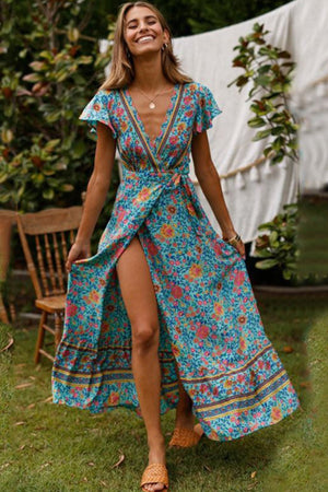 Woman wearing Bohemian floral print wrap dress with V-neck and high slit outdoors