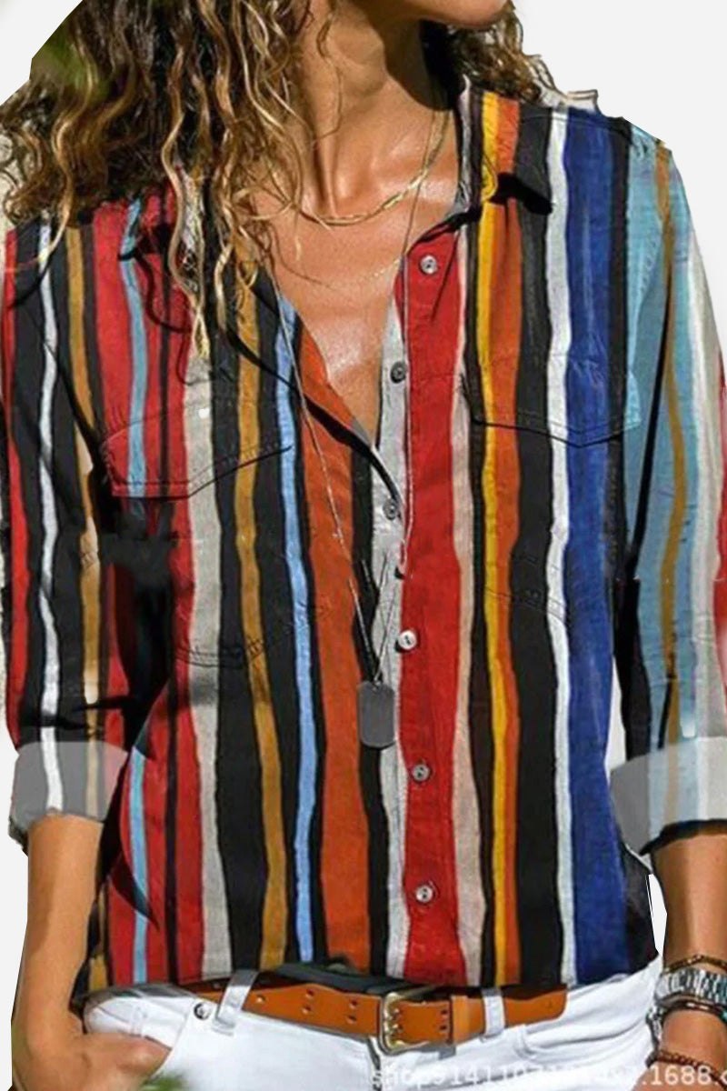 Woman wearing long-sleeved casual printed loose shirt with colorful vertical stripes and white pants
