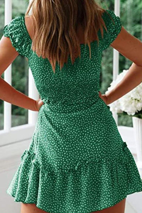 Woman wearing green sweetheart collar printed ruffled maxi dress with high waist and ruffle sleeves.