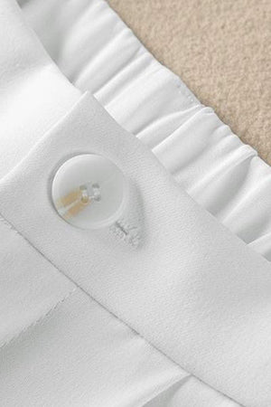 Close-up of white casual loose wide-leg high-waisted pants waistband with button detail