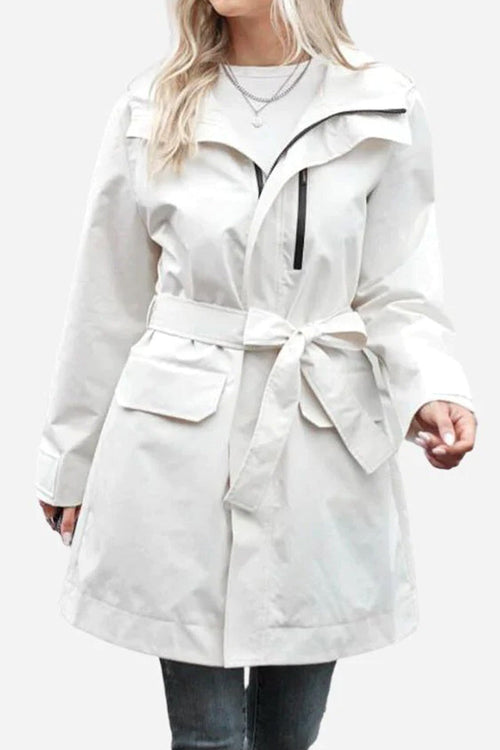 White water-resistant windbreaker trench jacket with belt and pockets on female model