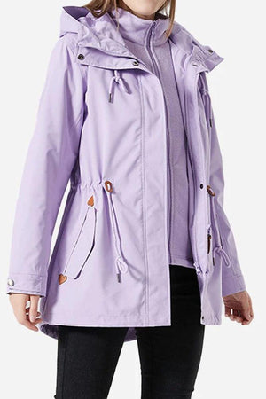 Woman wearing a lavender Versatile Chic Two-Piece Windbreaker Set with adjustable hood and slim-fit design