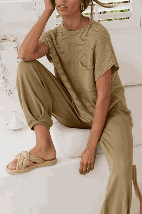 Woman wearing a beige Comfy Couture Knit Sweater two-piece set with knit pullover and high-waisted pants sitting indoors