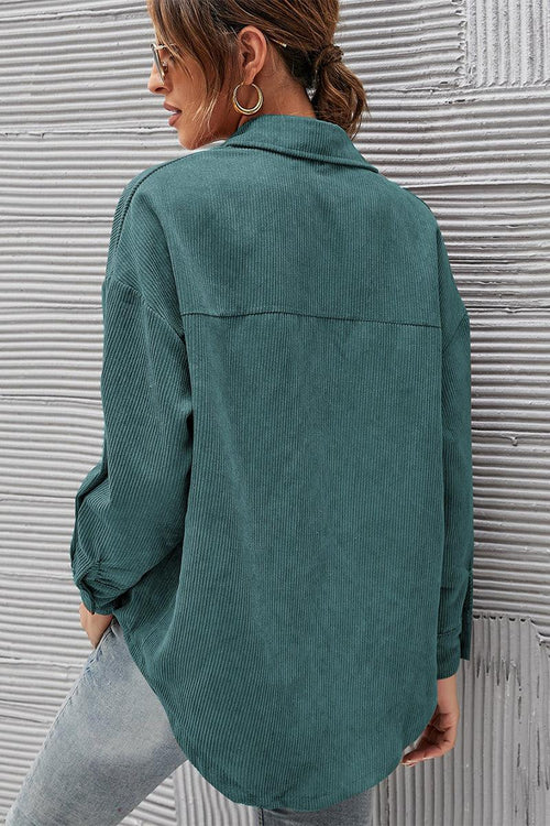 Woman wearing teal sleek suede oversized button-down shirt from back side