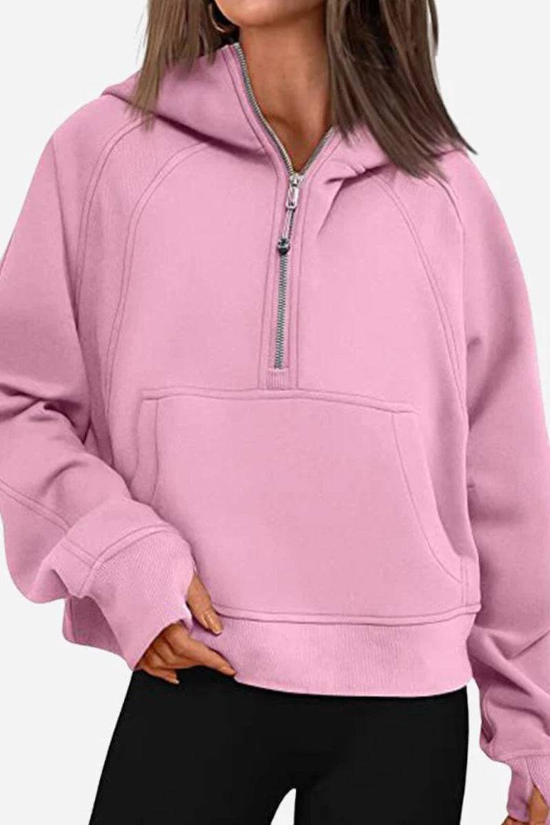 Woman wearing a pink cozy oversized half-zip fleece pullover sweatshirt with a front pocket and zipper detail