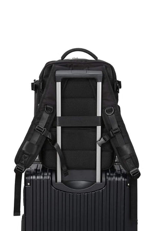 Chic Wanderlust Waterproof Backpack attached to suitcase handle, black ergonomic travel bag with padded straps and durable fabric