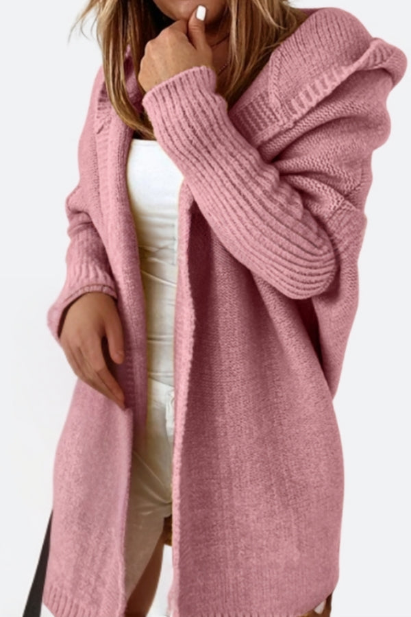 Pink warm oversized hooded cardigan with ribbed sleeves and relaxed fit on a model