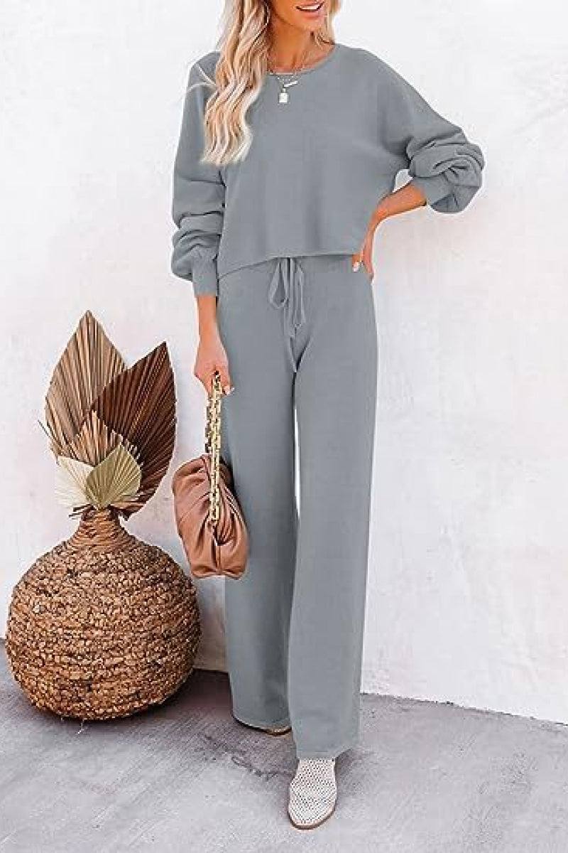 Woman wearing a gray round neck loose fit cozy two-piece set with long sleeves and wide-leg pants.