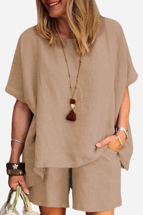 Woman wearing beige comfy linen-like shirt and shorts two-piece set with casual accessories