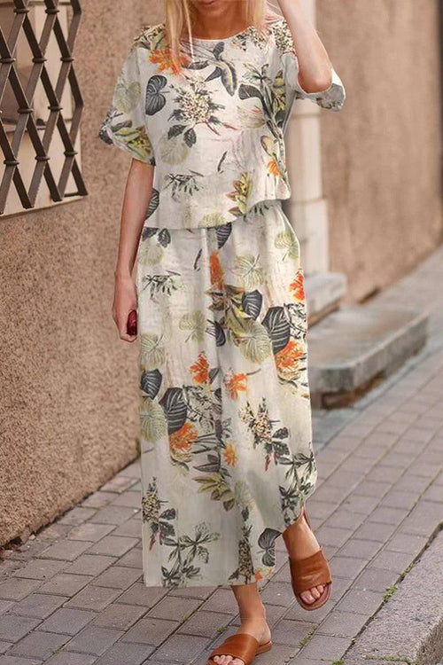 Woman wearing a floral print loose fit co-ord set with wide-leg pants and relaxed top walking outdoors.