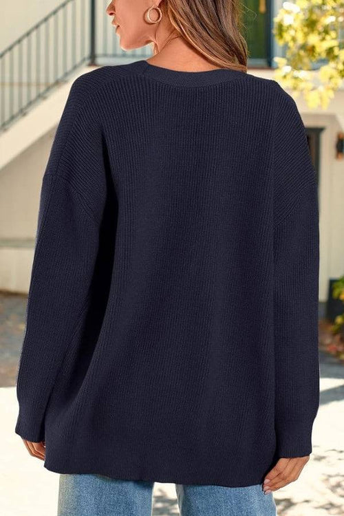 Relaxed fit oversized navy knitwear cardigan back view on model outdoors