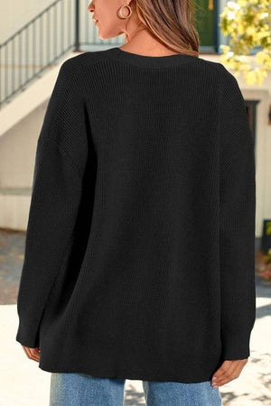 Relaxed fit oversized black knitwear cardigan with long sleeves and lightweight cozy fabric.