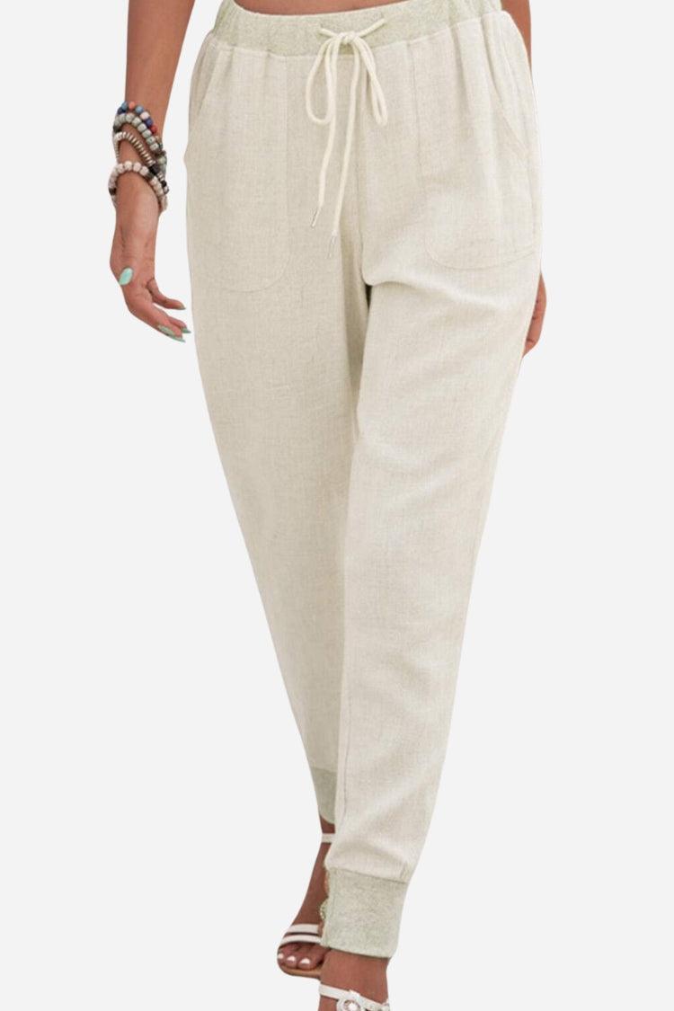 Women wearing relaxed chic elastic ankles pants in light beige with drawstring waist and cuffed ankles