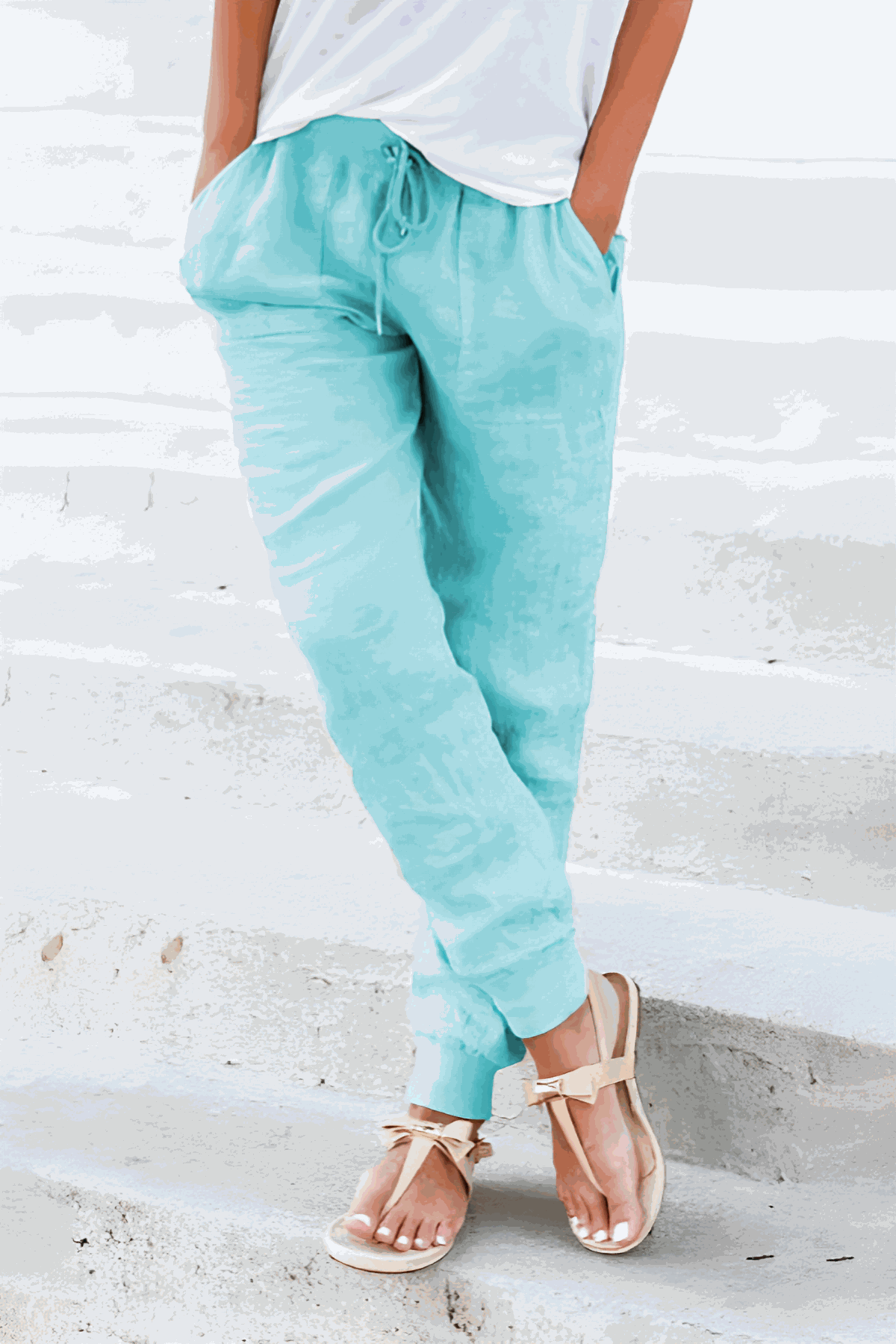 Light blue relaxed chic elastic ankles pants with drawstring waist and tapered cuffs, styled with casual sandals