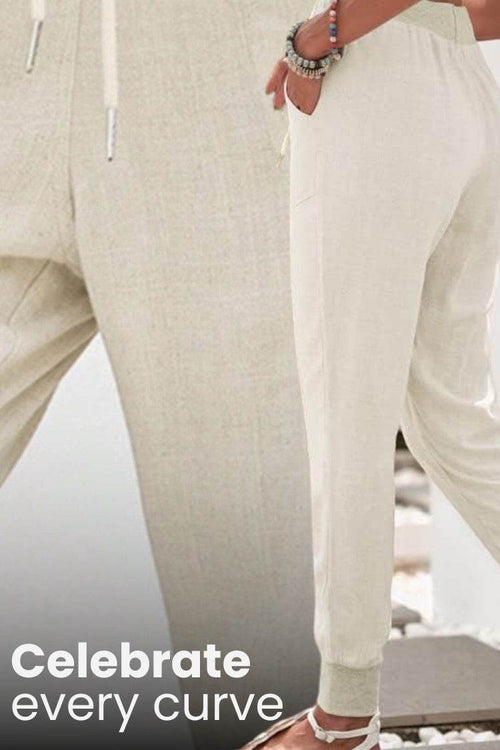 Beige relaxed chic elastic ankles pants with a comfortable fit and tapered cuffs.