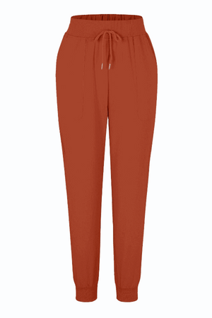 rust-colored relaxed chic elastic ankles pants with drawstring waist and tapered fit