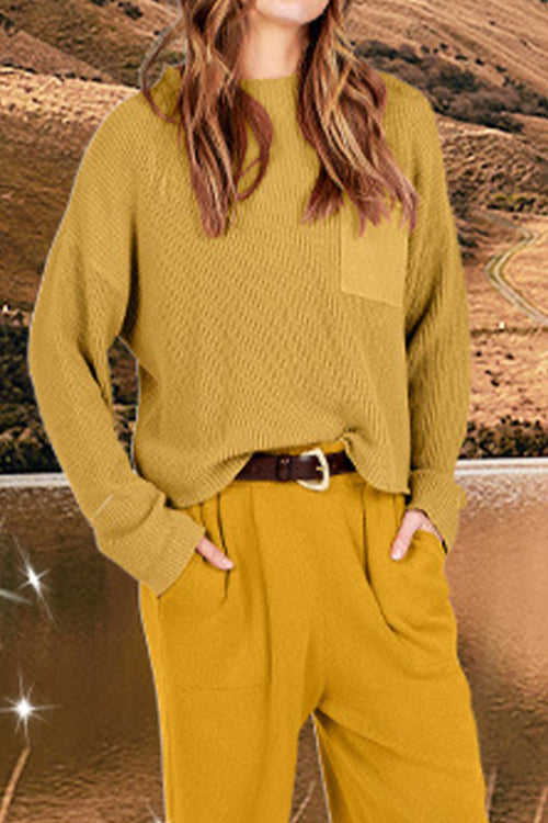 Woman wearing European minimalism relaxed sweater top and trouser set in khaki color outdoors