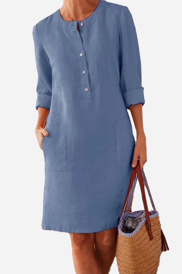 Blue cotton dress with 3/4 rolled sleeves, button front, knee-length, and pockets, perfect for summer and casual wear.