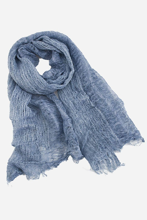Lightweight linen scarf in soft blue with frayed edges, breathable and versatile accessory.