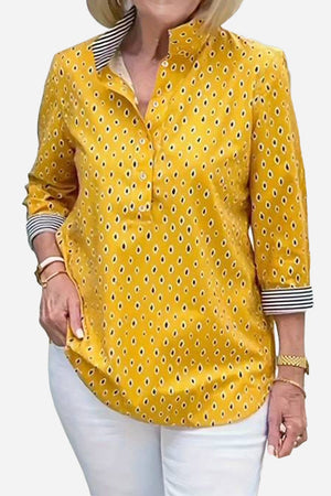 Yellow Boho Chic Resort Blouse with polka dots and striped collar and cuffs, three-quarter sleeves, lightweight fabric, styled on woman with white pants