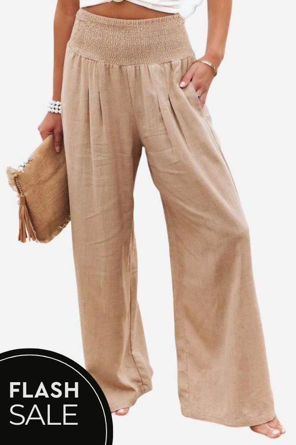 Woman wearing high-waist polyester palazzo pants with wide-leg fit and pockets
