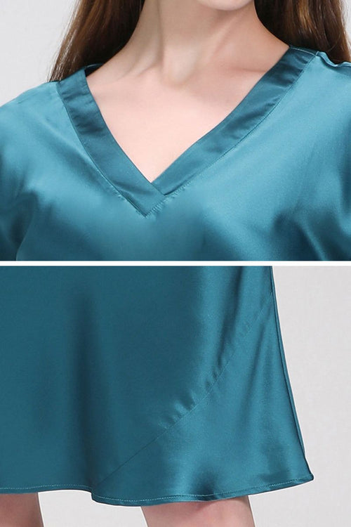 Close-up of teal Mulberry Silk V-Neck Nightgown showing smooth silk fabric texture and flowing hemline.