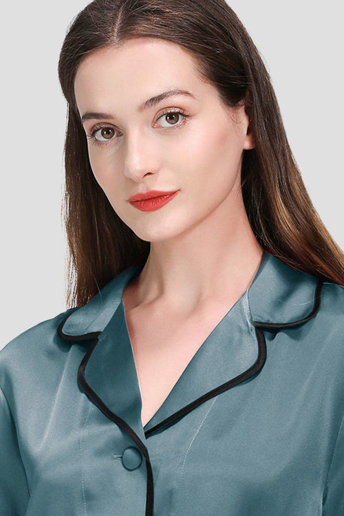 woman wearing teal mulberry silk hemd trimmed pajama top with black hems