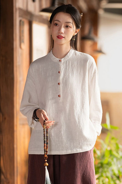 Woman wearing one size ramie linen & cotton blouse with long sleeves and button front, styled casually