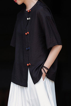 Eco-friendly regenerated cellulose blouse in black with asymmetrical buttons and oversized fit