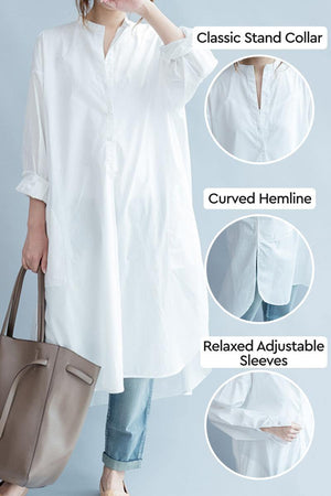 White pure cotton long shirt with classic stand collar, curved hemline, and relaxed adjustable sleeves, styled oversized for casual elegance.