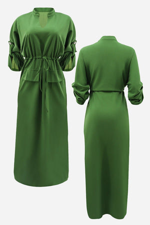 Green All-Day Drape Dress with adjustable waist tie, button-tab sleeves, front slit, and breathable polyester fabric.