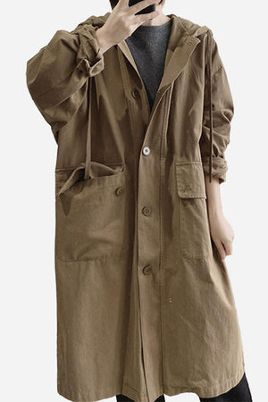 Brown travel-ready hooded windbreaker made of breathable 100% cotton with snap buttons and large pockets.