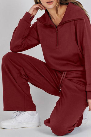 Women wearing a cozy maroon Loungewear Buttersoft Tracksuit Set with zip-up top and wide-leg pants paired with white sneakers