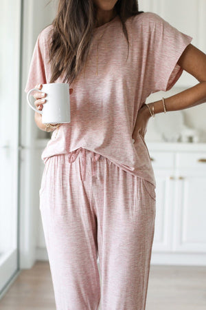 woman wearing pink ultra-soft two-piece loungewear set holding white mug indoors