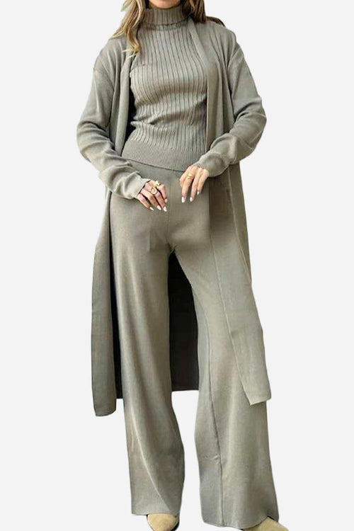 Woman wearing a one-size premium three-piece collection in soft beige fabric with ribbed top, wide-leg pants, and long cardigan