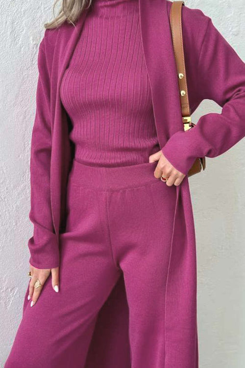 Woman wearing a magenta one-size three-piece collection with ribbed top, pants, and long cardigan