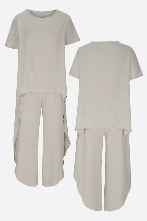 Relaxed linen-like travel 2-piece set in beige, lightweight and wrinkle-resistant outfit with short-sleeve top and loose pants.