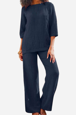 woman wearing navy textured two-piece set with loose fit and three-quarter sleeves