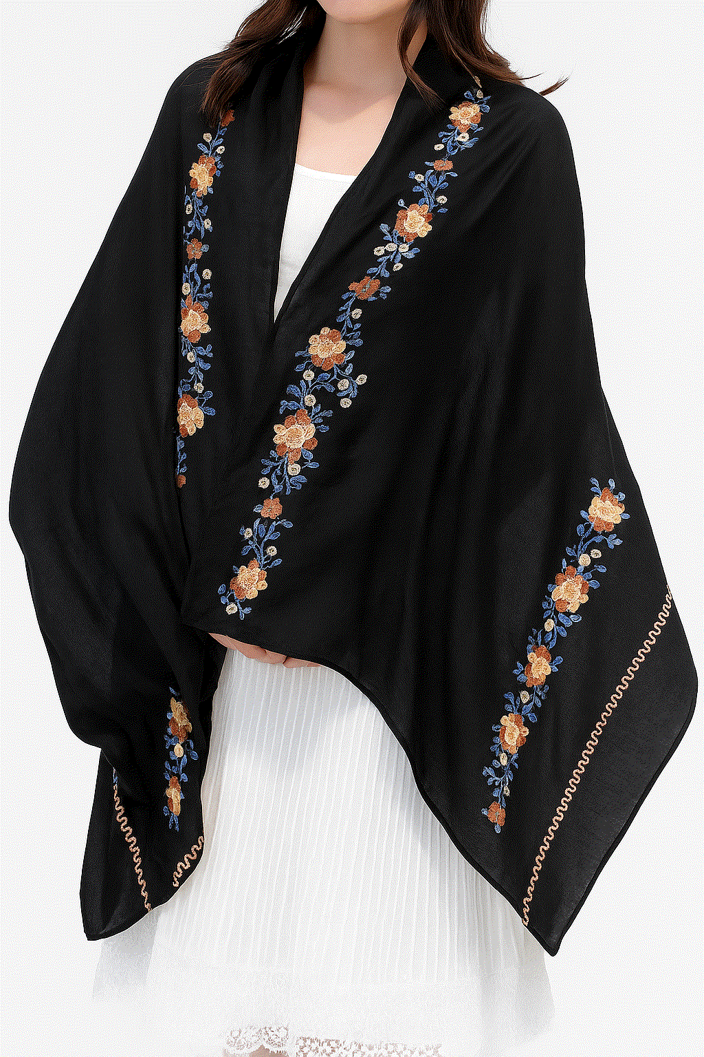 Black embroidered travel-must shawl wrap with floral design worn over white dress