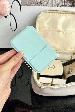 Compact travel pocket mirror with durable PU leather cover in light blue, perfect for on-the-go touch-ups.