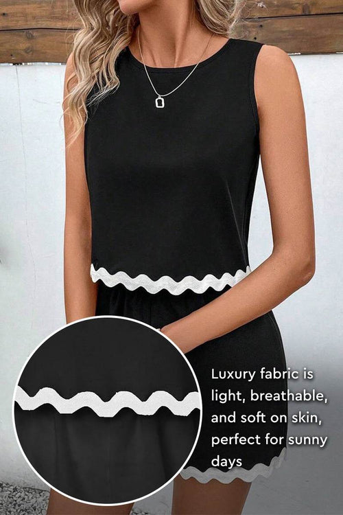 Flattering Coastal Scallop two-piece set in black with scalloped hem, made from light, breathable viscose fabric for comfortable, chic wear.