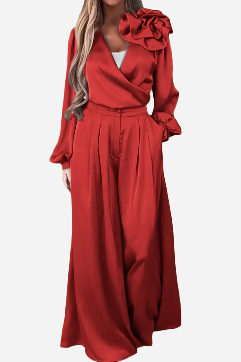 Elegant red satin two-piece set with statement shoulder blouse and flowing palazzo pants