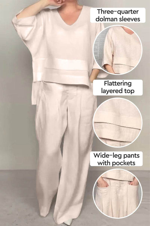 Woman wearing Atelier Serenity layered two-piece set with three-quarter dolman sleeves, layered V-neck top, and wide-leg pants with pockets in neutral tone