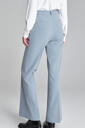 Back view of professional retro stretch trousers in light blue with high-waisted, straight-leg fit worn with white blouse and black shoes