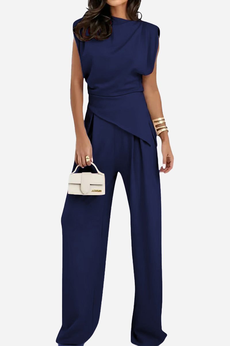Woman wearing navy blue Manhattan Lines Draped sleeveless two-piece set with asymmetrical draped top and wide-leg pants.