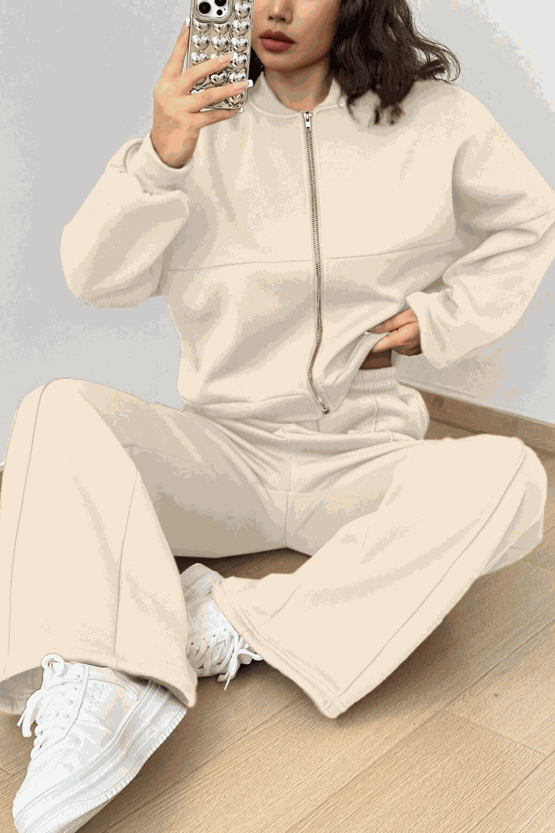 The Voyager Zip Set cream zip-front sweatshirt and wide-leg joggers travel outfit with pockets and white sneakers