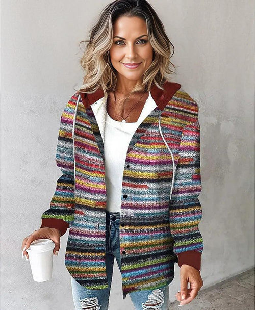 Woman wearing colorful Highland Plaid Shacket with hood and button-front closure holding coffee cup