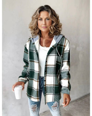 Woman wearing Highland Plaid Shacket with green and white plaid pattern, soft fleece lining, attached hood, and button-front closure.