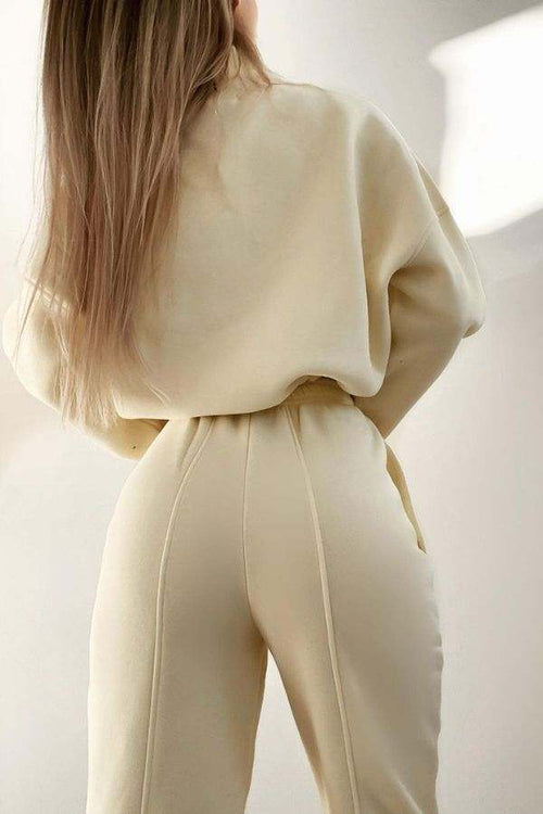 Woman wearing beige Storm Sweater Mock Neck athleisure set with relaxed fit and clean lines